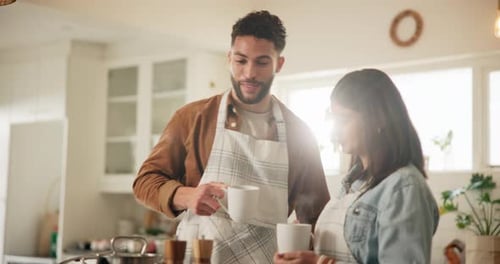 Couple Talking in Kitchen with Mugs