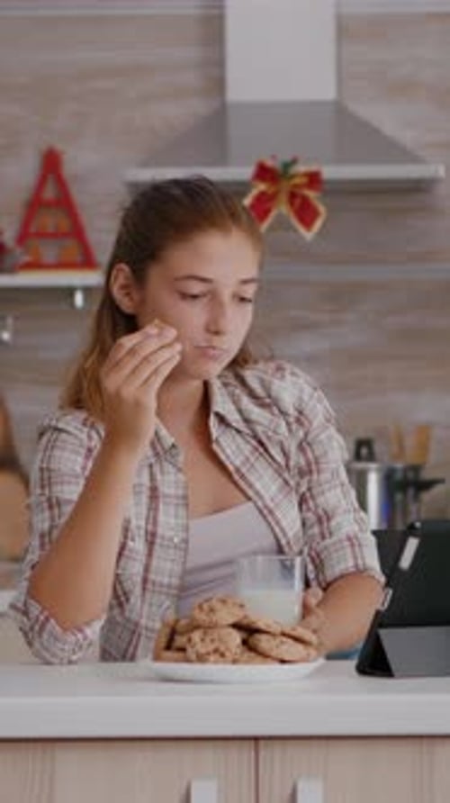 Vertical Video Portrait of Children Eating Baked Delicious Cookies Drinking Milk While Watching