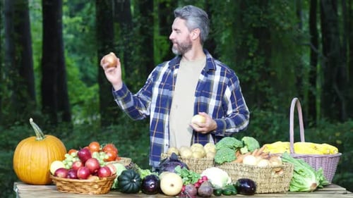 Gray Haired Man with Fresh Vegetables in Forest