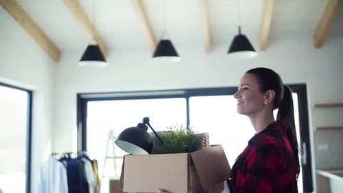 Woman Carrying Box into Bright, Modern Home