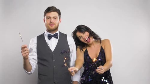 Happy Couple Celebrates with Sparklers in Studio Setting