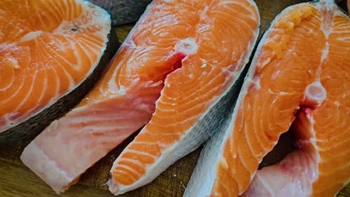 Fresh Salmon Steaks Close Up on Wood Surface