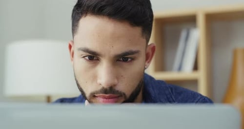 4k video footage of a young businessman using a laptop in an office at work
