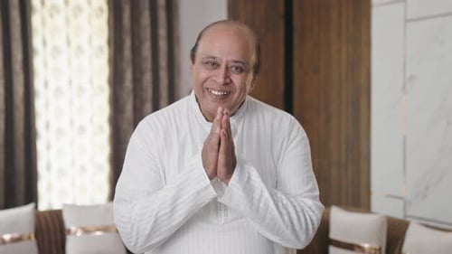 Indian old man doing Namaste and greetings