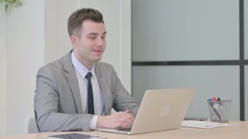 Man in Suit on Laptop Video Call