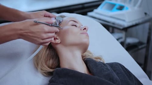 Woman Enjoying a Facial Treatment in a Relaxing Spa Setting Focused on Skincare and Wellness