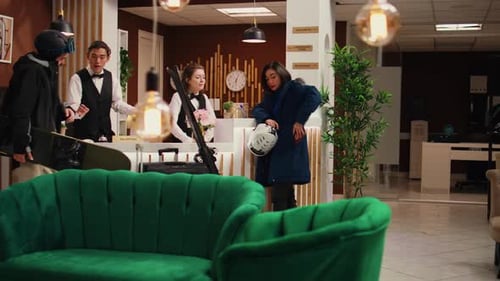 Group Checking into Hotel Reception with Snowboard