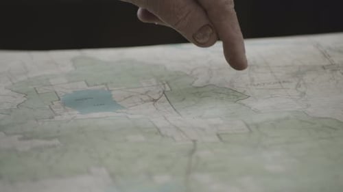 Index Finger Of An Old Man Pointing On An Area Around Idaho On The Map Of West Yellowstone In Montan