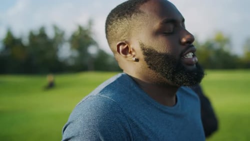 Closeup Of Exhausted African American Man Doing Cardio Workout On Road. Tired Athlete Running Mar...