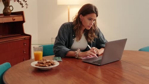 Woman Working at Home with Laptop and Snack