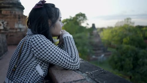 Young Teenage Thai Girl Enjoy Sunset View From Wat Yai Chai Mongkhon Temple in AyutthayaThailand