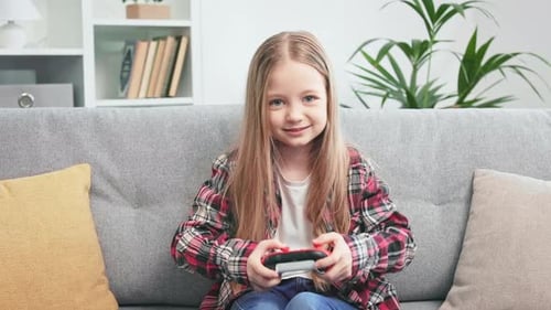 Happy Girl Playing Video Game at Home