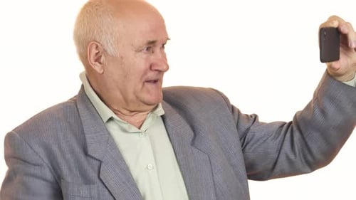 Smiling Senior Man Using Smartphone Device