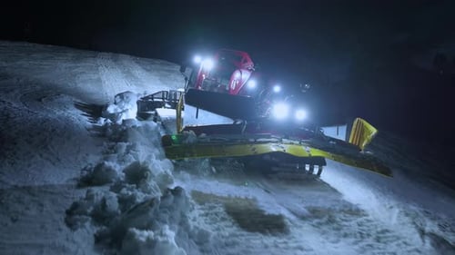 Night Aerial Close Up of Snow Groomer Preparing Ski Trail