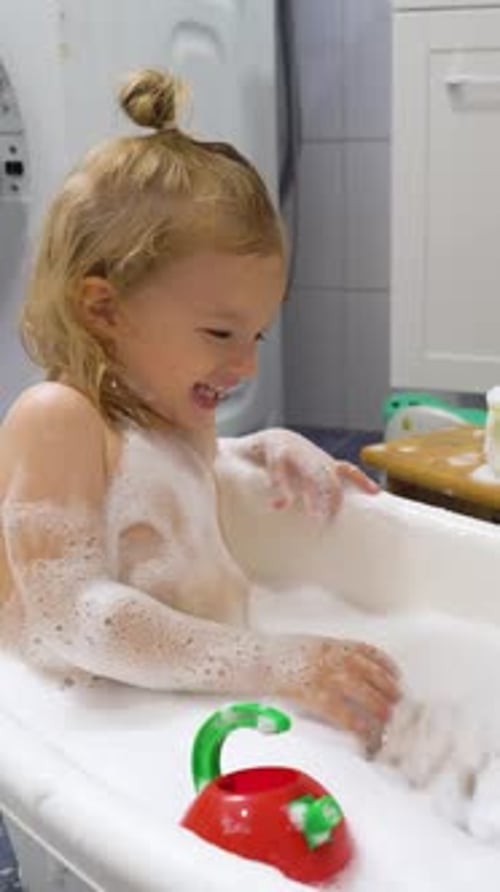 Child Being Washed in Soapy Bath Tub