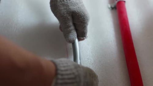 Installing Brass Fitting Into Plastic Pipe During Plumbing Installation