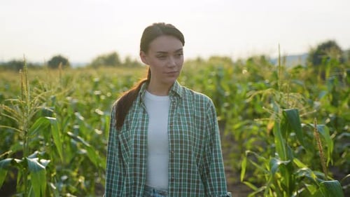 Young Woman Smiles in a Sunny Cornfield