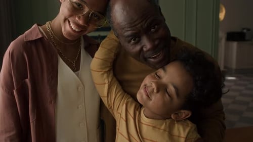 Warm Family Embrace Indoors with Child and Grandfather