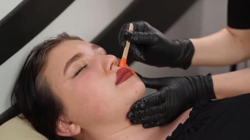 Young Woman Gets Facial Waxing Treatment