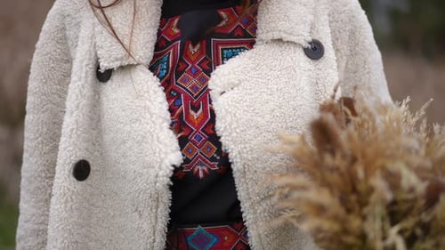 Unrecognizable Ukrainian Woman in Embroidered National Dress with Wheat Sheaf Standing Outdoors