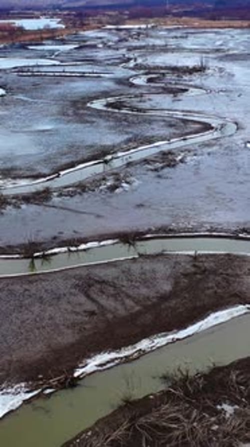 Tortuous river in muddy place. Ecological problems with water. Global warming.