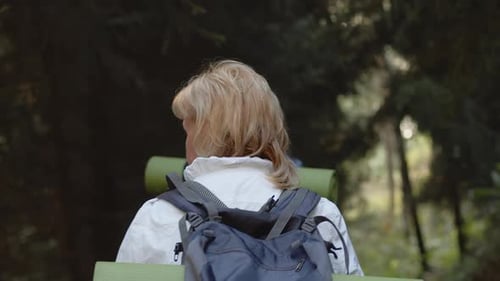Adults Hiking with Backpacks in a Forest