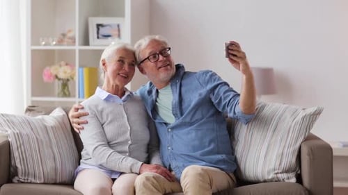 Senior Couple Taking Selfie with Mobile Phone at Home