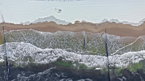 Cold Baltic sea and snowy beach at winter.