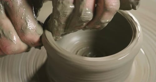 Hands Shaping Clay on Potter's Wheel