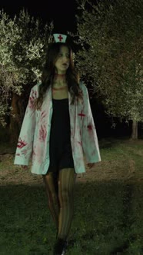 Zombie Woman Walks In Scary Forest With Trees On Halloween Night
