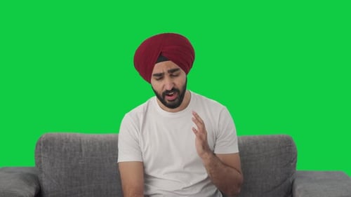 Sick Sikh Indian man suffering from tooth pain Green screen