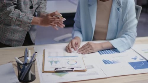 Adults Reviewing Data Documents in an Office