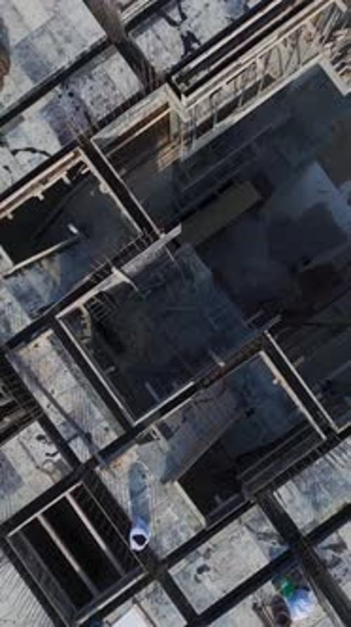 Vertical Video Aerial Perspective of Workers Installing Scaffolding for Concrete Floor Pouring at a