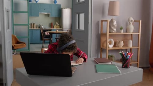 Child Studies with Laptop at Home Desk