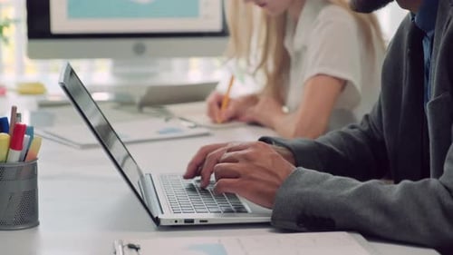 Office Worker Typing on Laptop at Desk