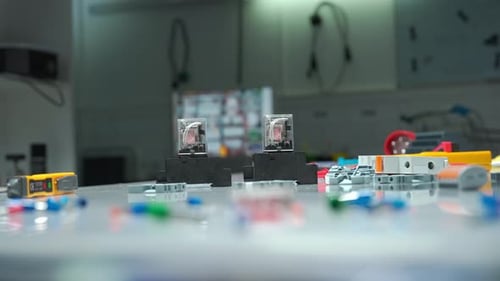 Electrician Lays Out on Table Relay with Electromagnetic Coils of Direct and Alternating Current Red