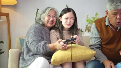 Generations Playing Video Games Together in Living Room