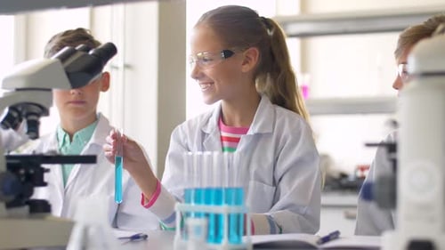 Children learning science looking at test tubes