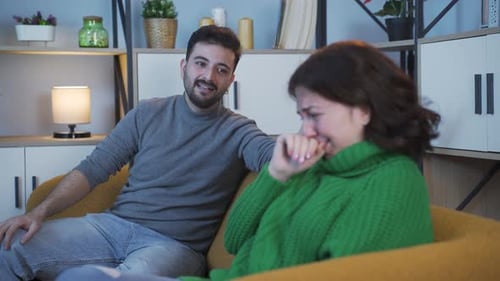 Sad Woman Cries on Couch with Friend