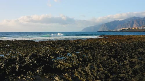 Ocean Waves Crashing on the Rocky Shore of the Beach