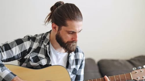 Man Plays Guitar in an Apartment