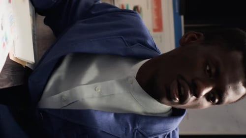 Man And Woman Reviewing Paperwork In Workplace