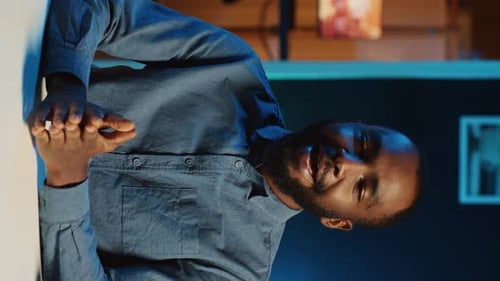 Man Discussing Technology in Modern Workplace Environment