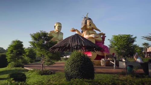4k Ganesha elephant-headed Hindu god of beginnings and golden monk statue of Luang Pu Thuat. Pan aro