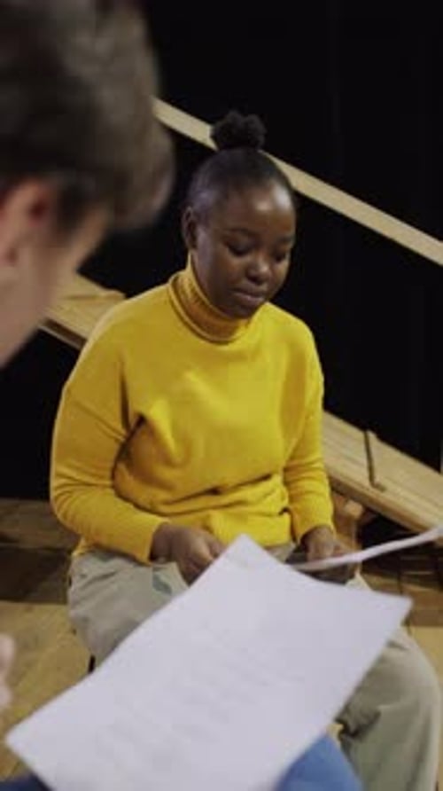 Actress Memorizing Script on Rehearsal with Scene Partner in Theatre