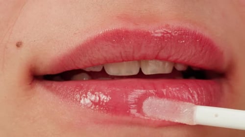 Beauty Lip Care Young Woman Applying Hygienic Lipstick on Lips Closeup on Pink Background Makeup