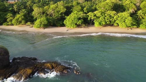 Aerial view of rocky remote tropical beach in National park of Manuel Antonio in Costa Rica during s