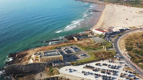 Aerial Drone Shot of Sandy Beach and Parking Area on Sunny Day
