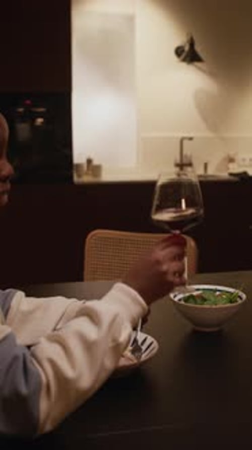 Adults Sharing a Meal and Wine at Home