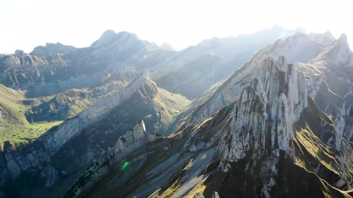 Aerial flyover alongside Schaefler ridge in Appenzell, Switzerland with side view of Alpstein cliffs